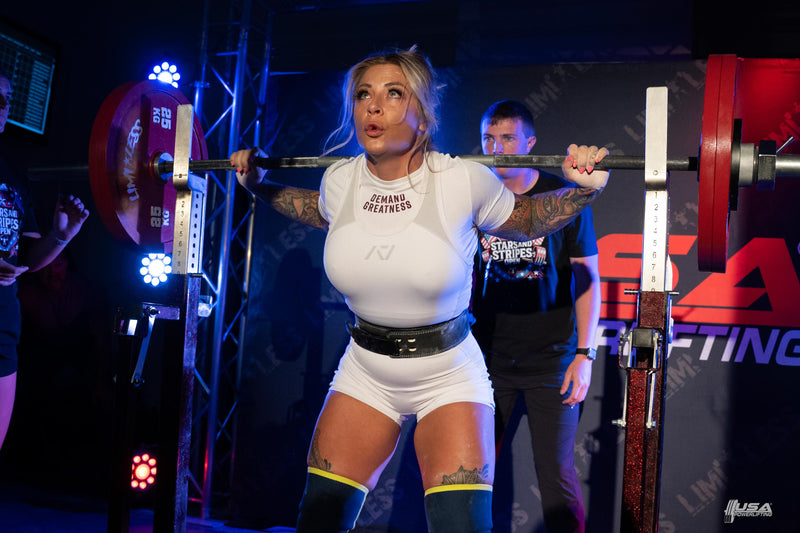Woman lifting weights at a powerlifting competition