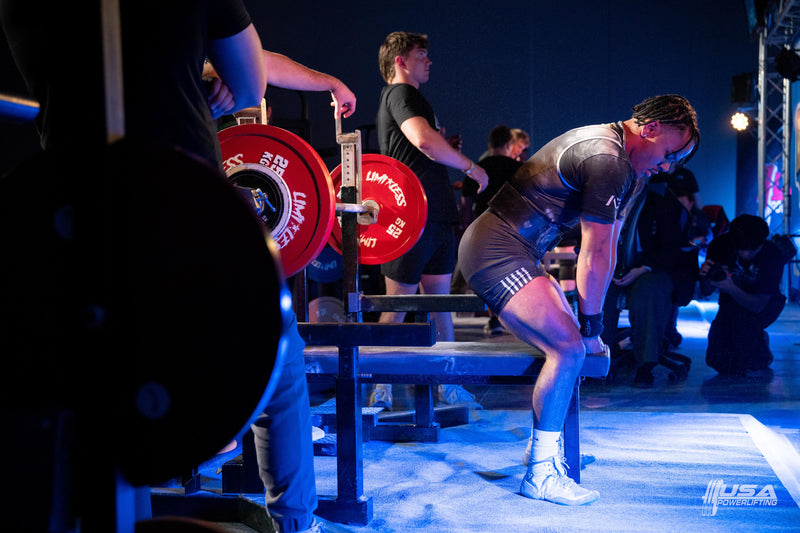 Athlete preparing to lift weights at a USA Powerlifting competition hosted by Limitless Powerlifting
