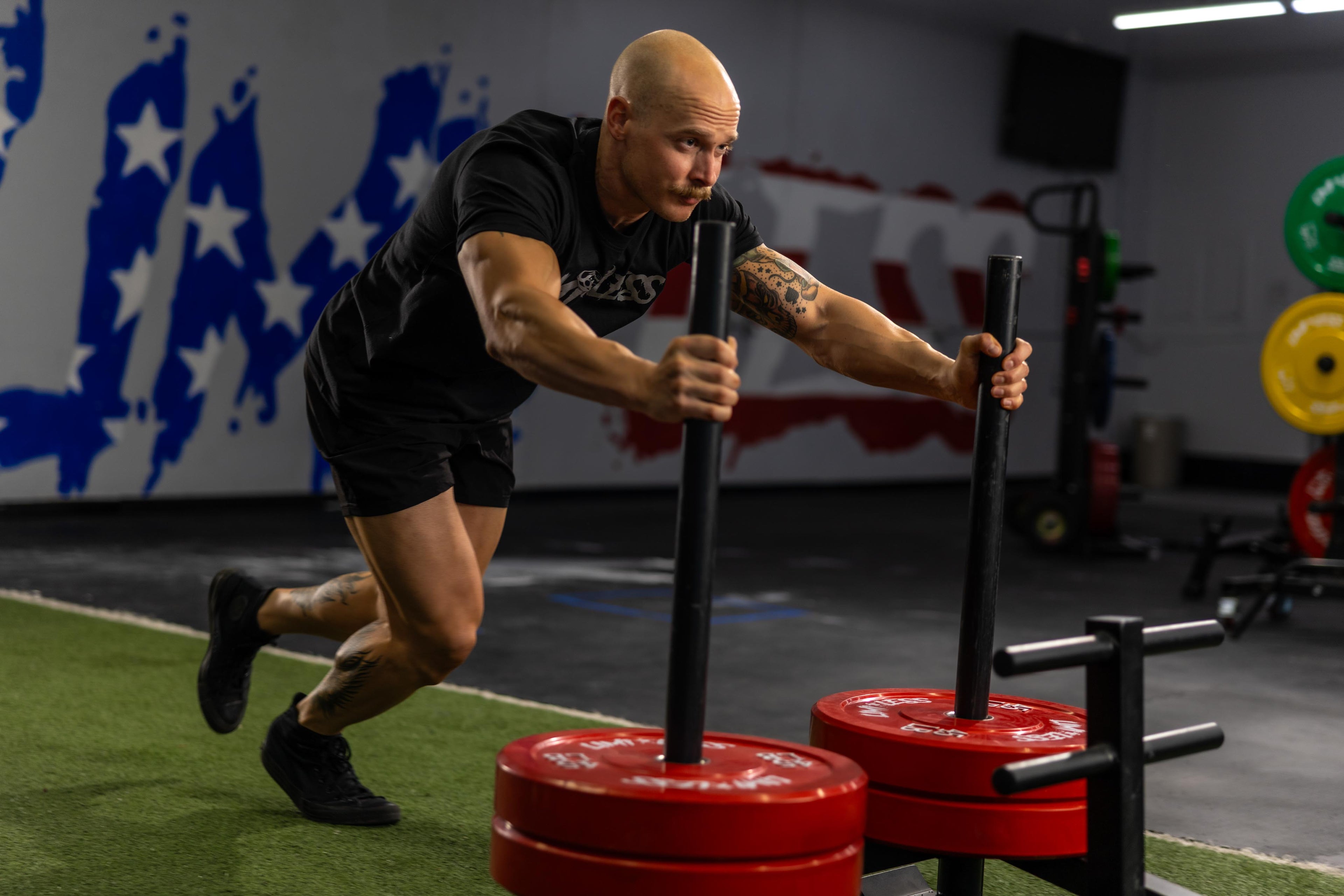 Man pushing sled at Limitless elite gym