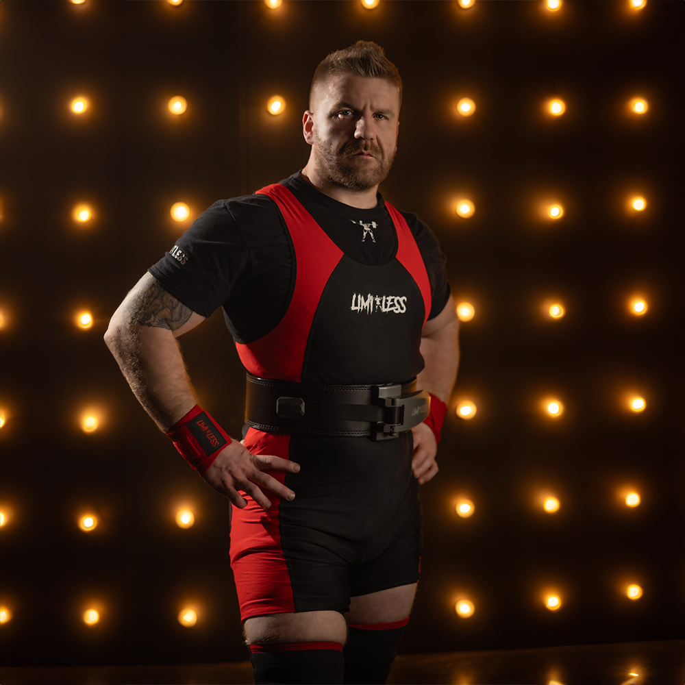 Quintin Meyer wearing a black and red outfit with 'LIMITLESS' branding against a backdrop of warm lights.