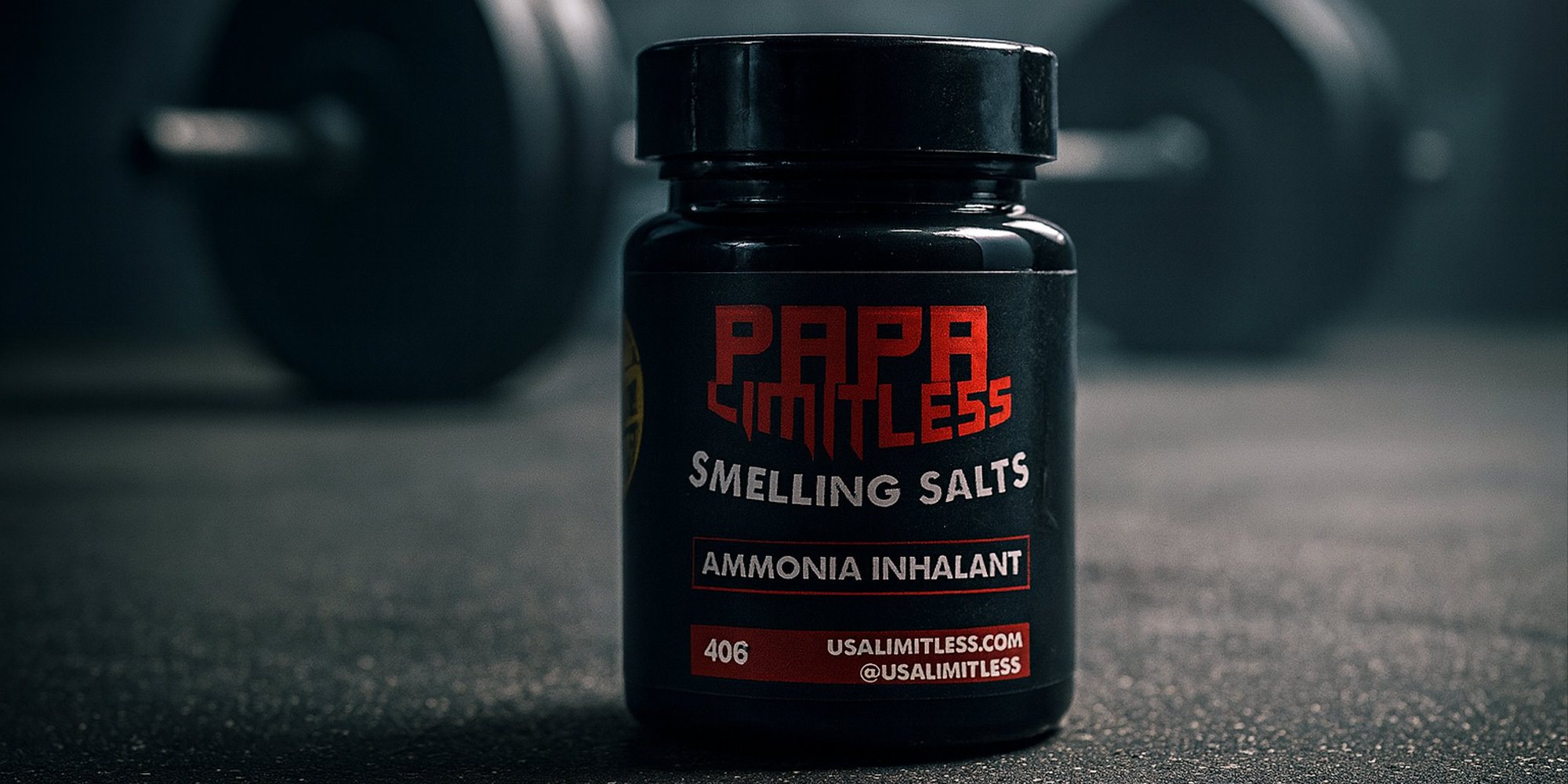 Papa Limitless Smelling Salts bottle with dumbbells in the background