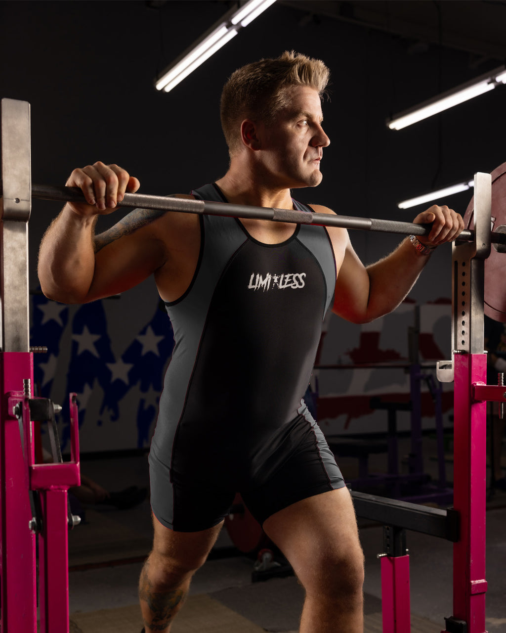 Quintin Meyer ready to squat wearing a grey/black limitles singlet