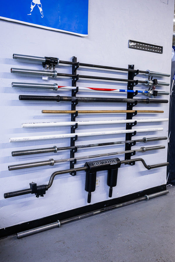 Barbell wall storage showcasing multiple styles of bars