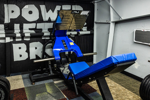 Leg machine positioned in front of wall mural