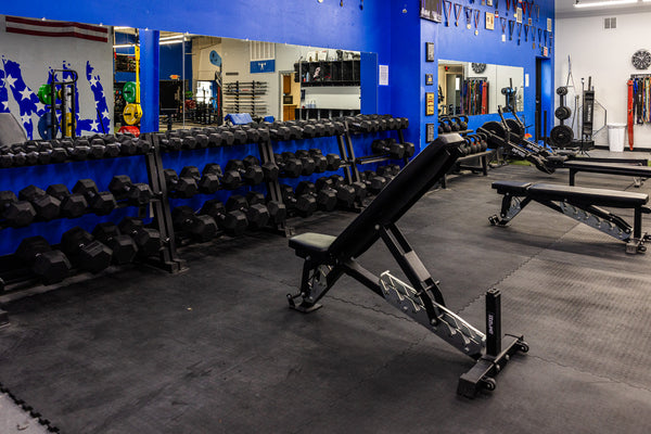Leg training machines inside the turf and strength room at Limitless Elite Gym