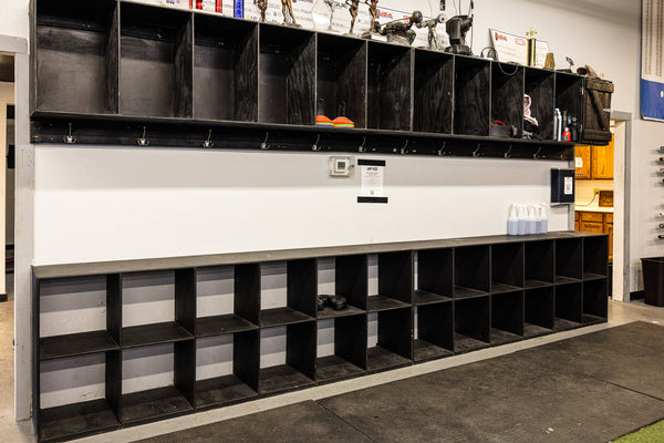 Horizontal gym bag storage rack in strength area