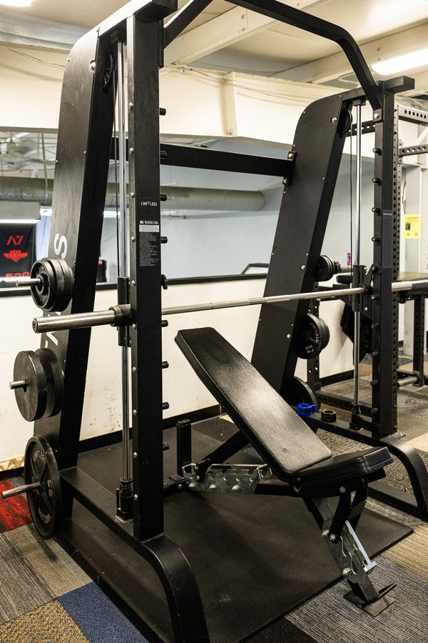 Row of squat racks and adjustable benches