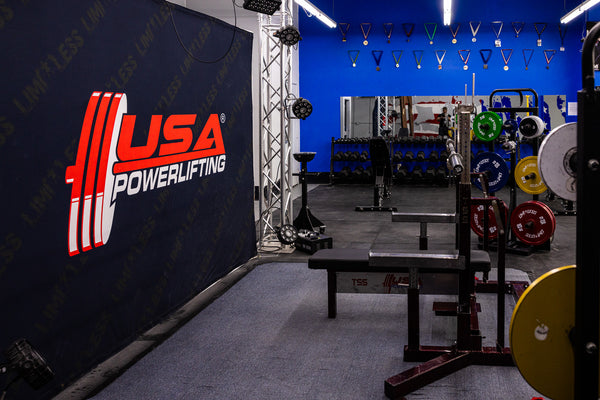 USA Powerlifting branded backdrop and platform inside Limitless Elite Gym