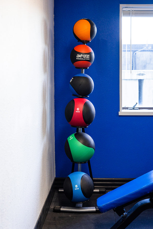 Colorful medicine balls stored neatly on vertical rack